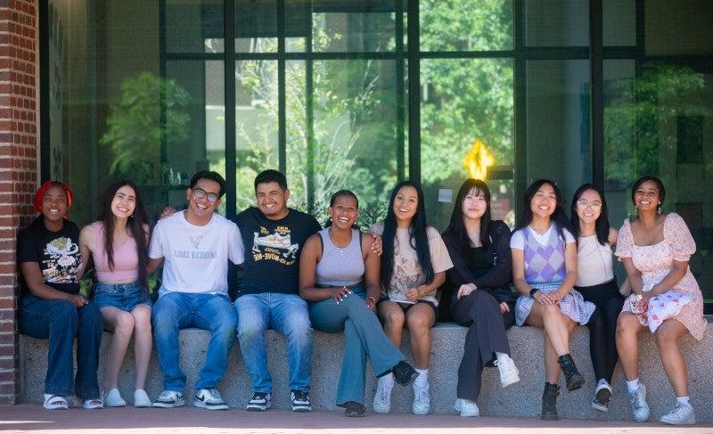 Students sitting on wall